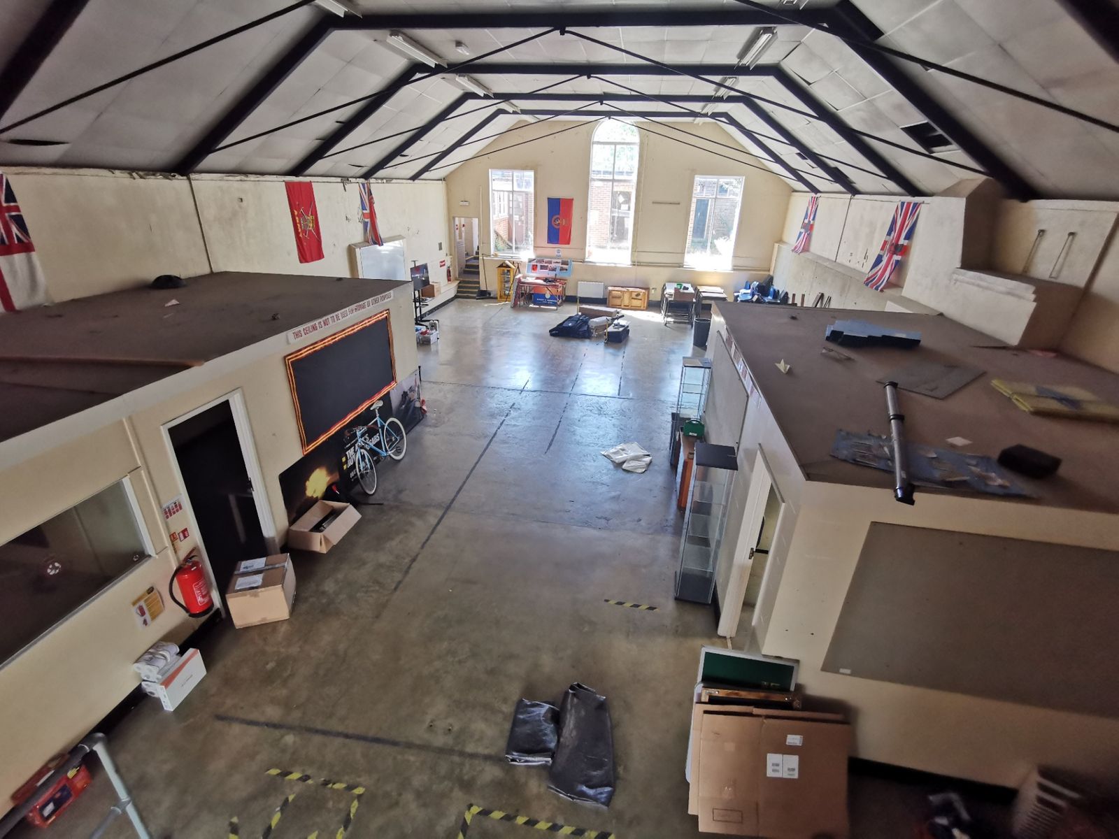 View across the main hall from the upper level towards the tall arched windows
